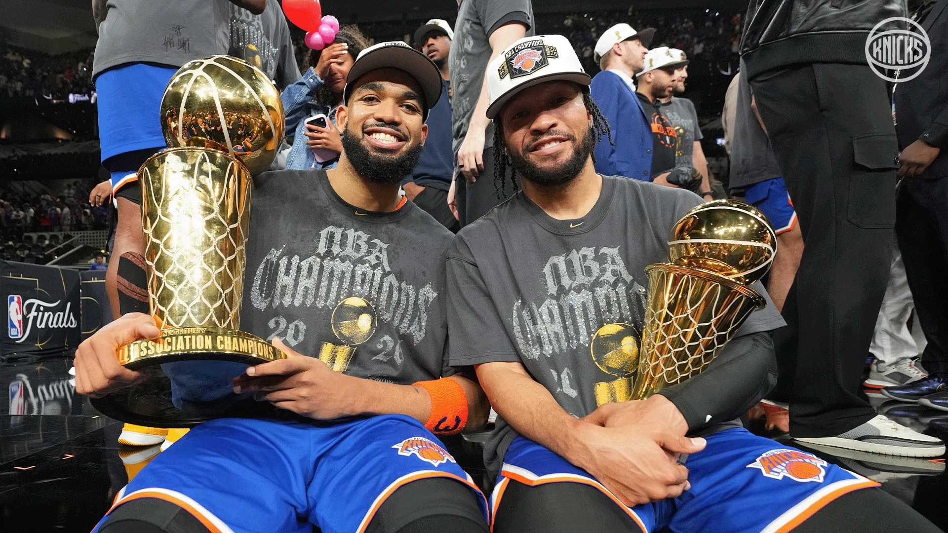 Karl-Anthony Towns and Mikal Bridges with the championship trophies